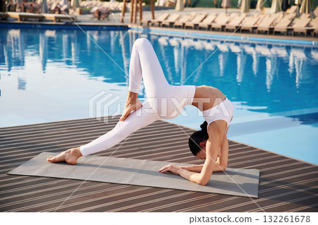 Legs and arms exercise. Fitness woman is near the pool Legs and arms exercise. Fitness woman is near the pool 132261678