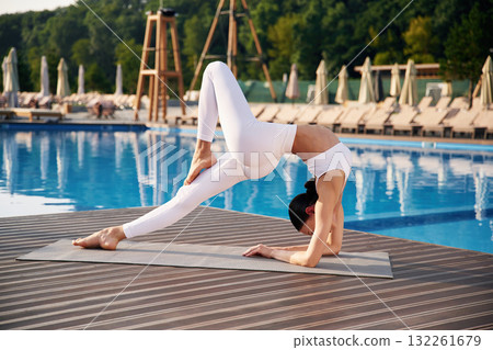 Legs and arms exercise. Fitness woman is near the pool 132261679