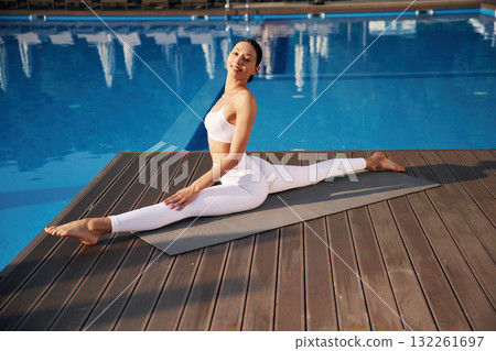 Doing twine. Fitness woman is near the pool 132261697