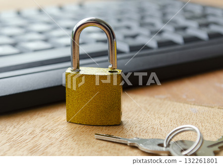 A golden padlock close up on a wooden desk beside a keyboard representing data privacy, internet safety and online access restriction. A golden padlock close up on a wooden desk beside a keyboard representing data privacy, internet safety and online access restriction. 132261801