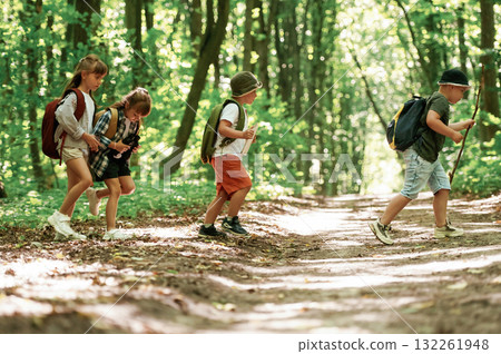 Weekend hiking. Kids in forest at summer daytime together 132261948
