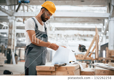 Man is busy. Industrial worker in wooden warehouse 132262258