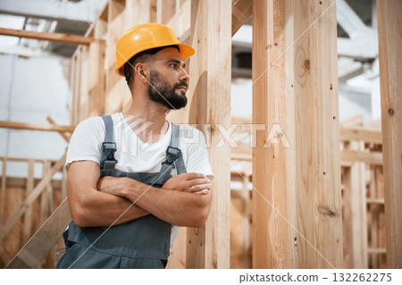 In yellow hardhat. Industrial worker in wooden warehouse In yellow hardhat. Industrial worker in wooden warehouse 132262275