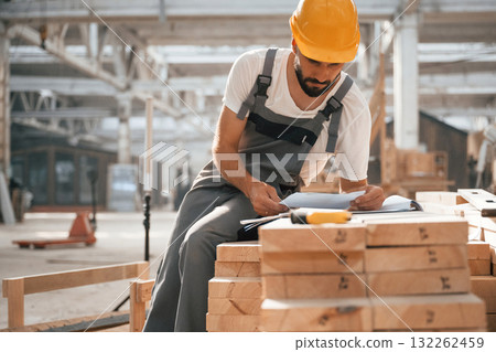 Contractor is busy. Industrial worker in wooden warehouse 132262459