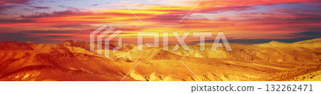 Mountainous desert with colorful cloudy sky. Judean desert in Israel at sunset. Horizontal banner 132262471