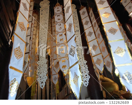 Intricate White and Gold Hanging Decorations with Zodiac Symbols in a Temple 132262689