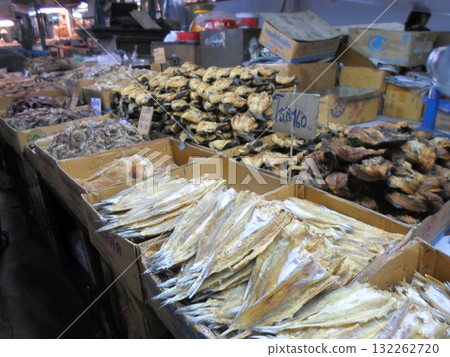 Market Stall with Various Types of Dried Fish in Wooden Boxes 132262720