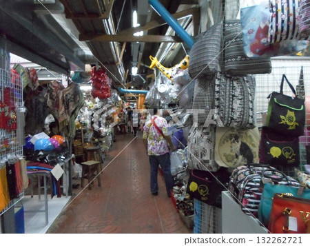 Narrow Market Aisle Filled with Colorful Goods and Shoppers 132262721