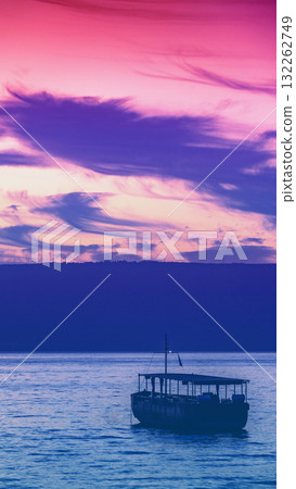 Beautiful Sea of Galilee in the morning in Northern Israel. Seascape with the boat during sunrise. Gradient color. Vertical banner 132262749