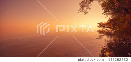 Minimalist landscape. Serene lake during sunrise. Magic sunrise over the lake. Misty early morning. Horizontal banner 132262880