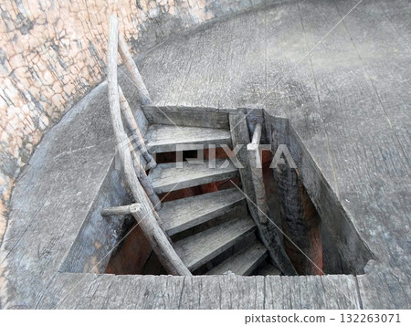 Rustic Wooden Stairs Leading Down in a Zoo Structure with Stone Surroundings 132263071