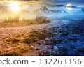 landscape with dirt road through field in fog in summer. day and night time change concept. yellow grass on the hills under sky with sun and moon. mystery atmosphere countryside composite photo 132263356