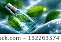 Elegant perfume bottle with water droplets and green leaves on satin fabric, symbolizing freshness, nature, and clean beauty 132263374