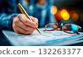 Close-up of a person writing notes in a 2026 planner outdoors, symbolizing organization, planning, and productivity 132263377