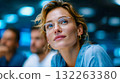 Close-up of a confident woman smiling during a meeting, symbolizing leadership, inspiration, and professional growth 132263380