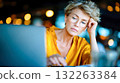 Focused mature woman with glasses working on laptop, representing concentration, online learning, and remote work 132263384