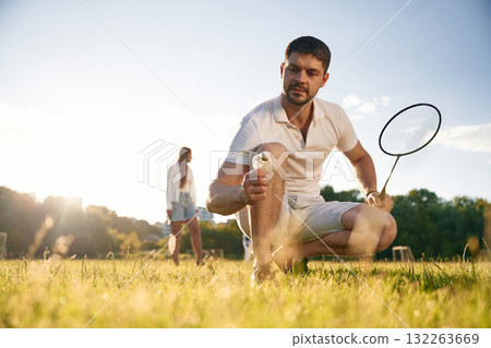Man with woman are playing badminton on the field 132263669