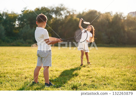 Happy kids are on the summer field Happy kids are on the summer field 132263879