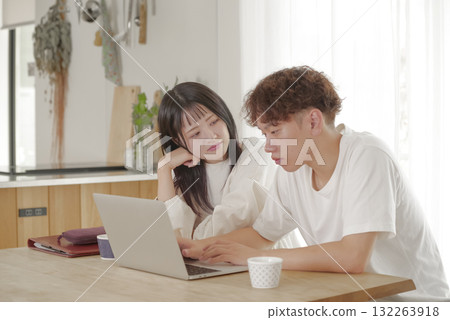 A couple managing their finances while looking at a computer 132263918