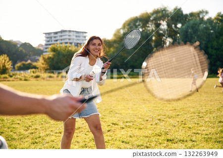 On the summer field. Man with woman are playing badminton 132263949