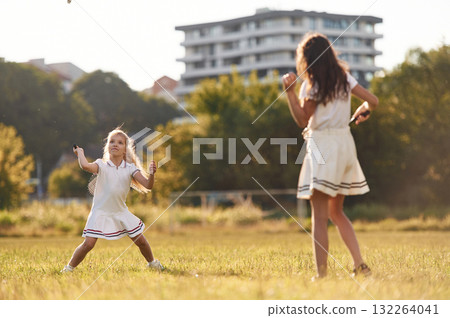 Game of badminton. Happy kids are on the summer field 132264041