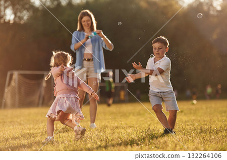 Woman with kids is on the summer field 132264106