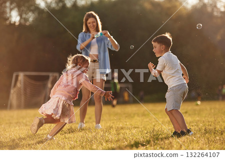 Woman with kids is on the summer field 132264107