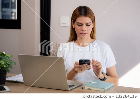 Young caucasian businesswoman texting with serious and concentration with laptop. 132264139