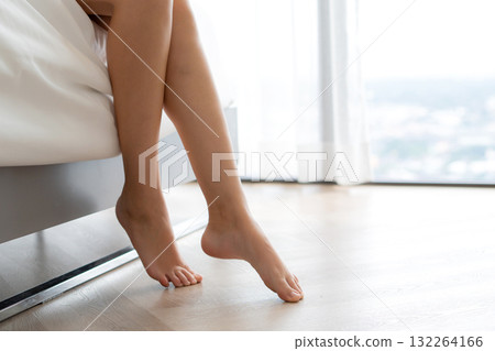 Young caucasian woman sitting peaceful on bed in bedroom for relax in morning. 132264166