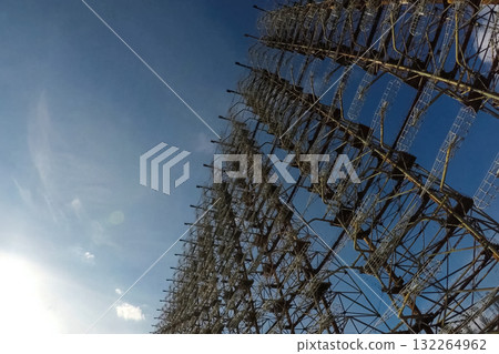Radar arc in Chernobyl. Old collapsing radar antenna on sky background Radar arc in Chernobyl. Old collapsing radar antenna on sky background 132264962