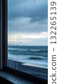 Raindrops on the window overlooking the sea, background. Gloomy autumn day, no people, vertical image. 132265139