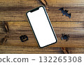 Mockup, smartphone, paper black bat, spider and pumpkin on wooden background. Halloween background. 132265308