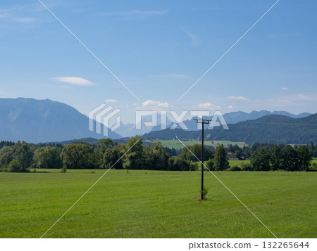 Freilassing, Germany - July 26th 2024: Beautiful landscape in the foot hills of the Alps towards the Watzmann massif. Freilassing, Germany - July 26th 2024: Beautiful landscape in the foot hills of the Alps towards the Watzmann massif. 132265644