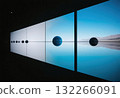 An art installation featuring a celestial sphere reflected in still water, evoking a sense of tranquility and mystery. 132266091