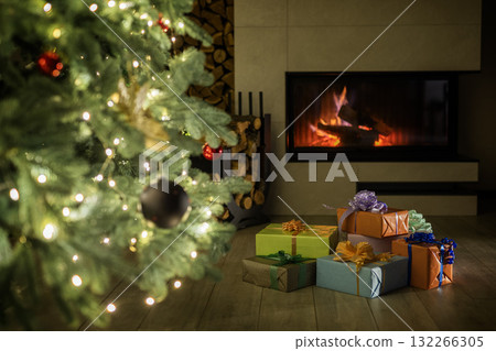 Warm cozy living room with a glowing fireplace, decorated Christmas tree, and beautifully wrapped presents on the floor creating a festive holiday atmosphere. Warm cozy living room with a glowing fireplace, decorated Christmas tree, and beautifully wrapped presents on the floor creating a festive holiday atmosphere. 132266305