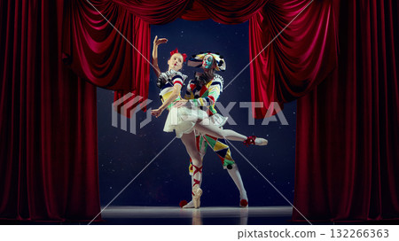 Embrace of motion. Mime and ballerina dancing in spotlight on theater stage. 132266363