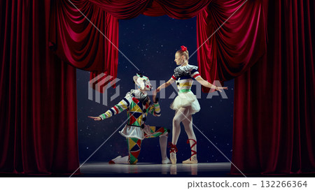 The art of connection. Mime kneeling before ballerina on stage with red curtain. 132266364