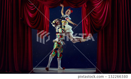 Lift of imagination. Mime lifting ballerina in ballet pose under red curtains. Lift of imagination. Mime lifting ballerina in ballet pose under red curtains. 132266380