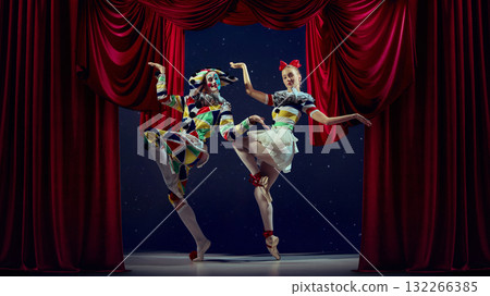 Spotlight rhythm. Mime and ballerina performing synchronized pose on theater stage. Spotlight rhythm. Mime and ballerina performing synchronized pose on theater stage. 132266385