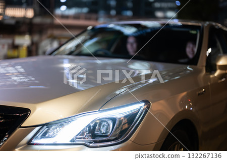 Men and women riding in cars 132267136