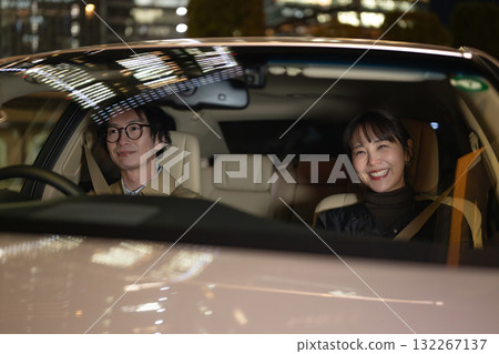 Men and women riding in cars 132267137