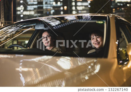 Men and women riding in cars 132267140