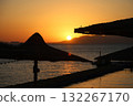 Sunrise over the sea against the backdrop of thatched umbrellas on the beach 132267170