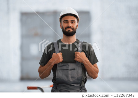 Beautiful portrait. Male worker is in the empty warehouse 132267342