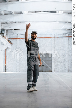 Huge area. Male worker is in the empty warehouse Huge area. Male worker is in the empty warehouse 132267351