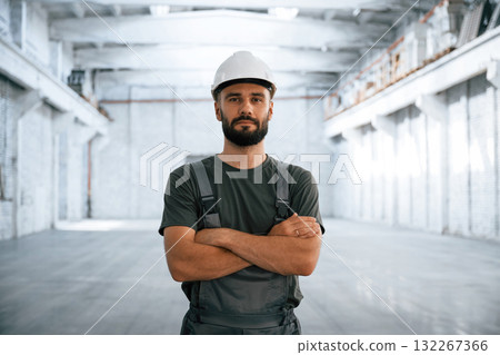 Beautiful portrait. Male worker is in the empty warehouse Beautiful portrait. Male worker is in the empty warehouse 132267366
