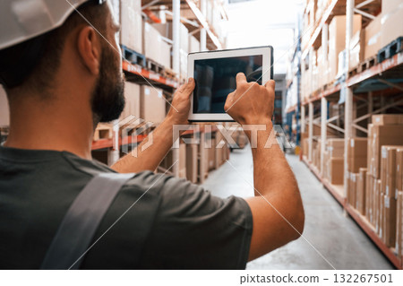 Copy space, holding digital tablet. Foreman is in the storehouse, shipping distribution business Copy space, holding digital tablet. Foreman is in the storehouse, shipping distribution business 132267501