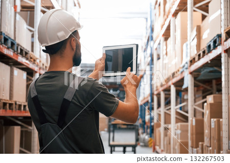 Copy space, holding digital tablet. Foreman is in the storehouse, shipping distribution business Copy space, holding digital tablet. Foreman is in the storehouse, shipping distribution business 132267503