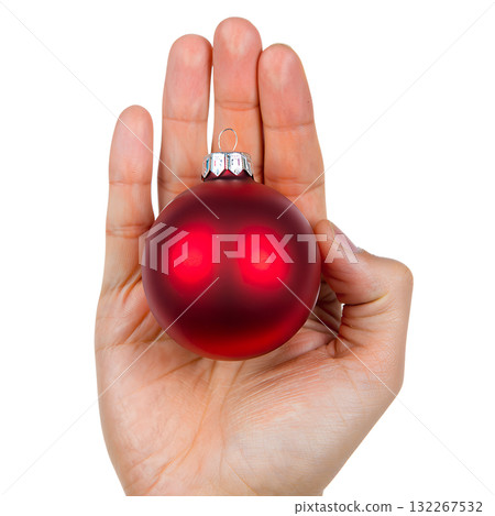 Single hand holding glossy red christmas ball ornament with metallic shine, isolated on transparent background for holiday designs Single hand holding glossy red christmas ball ornament with metallic shine, isolated on transparent background for holiday designs 132267532