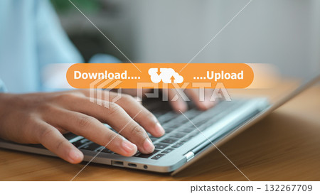 Hands typing on laptop with upload and download cloud data transfer concept Hands typing on laptop with upload and download cloud data transfer concept 132267709